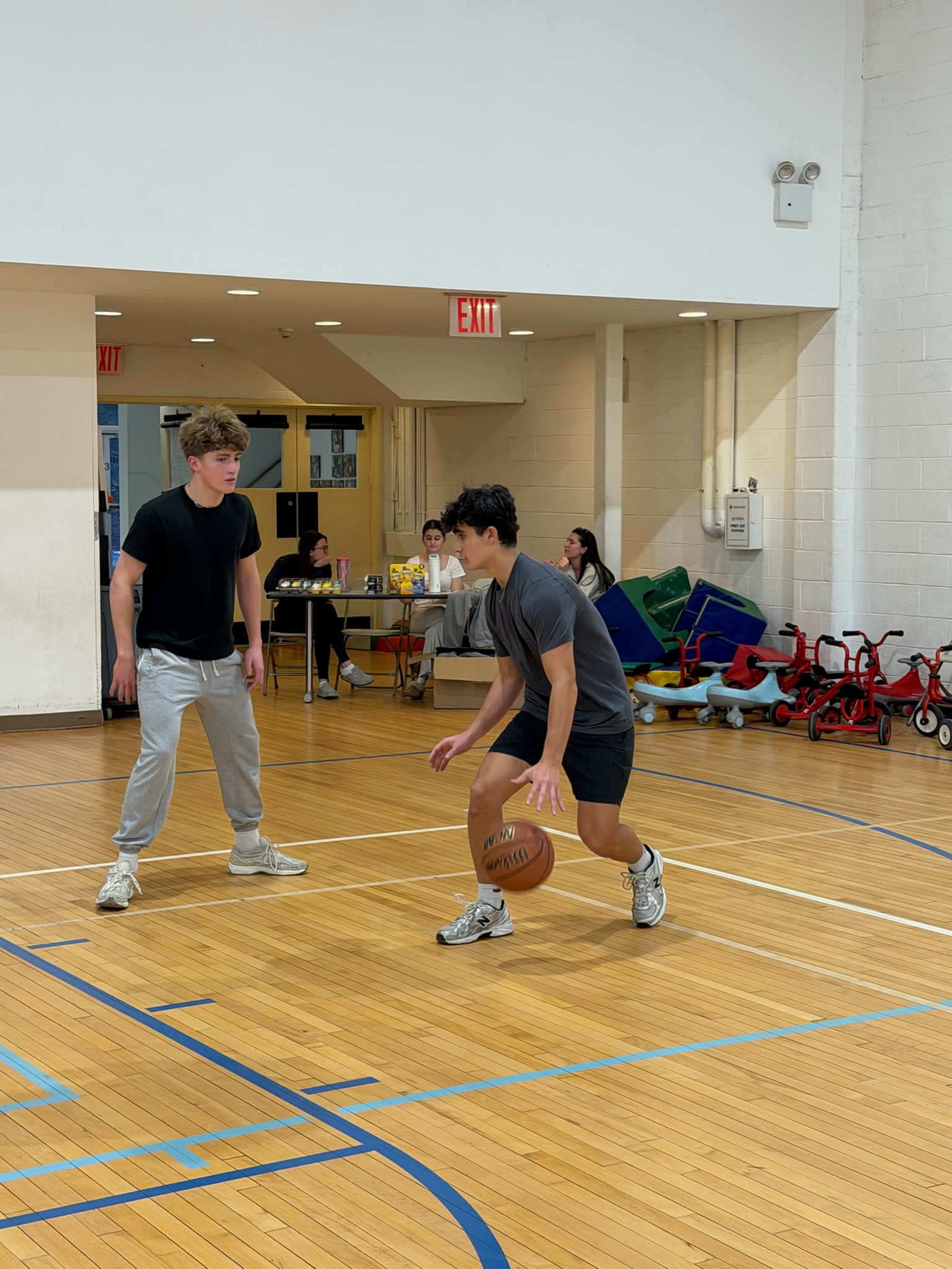 Two players facing off during the BBYO basketball tournament