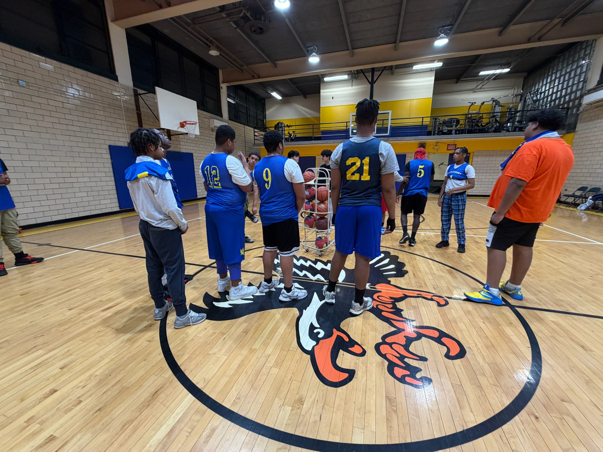 Basketball players gathering at center court for the December tournament