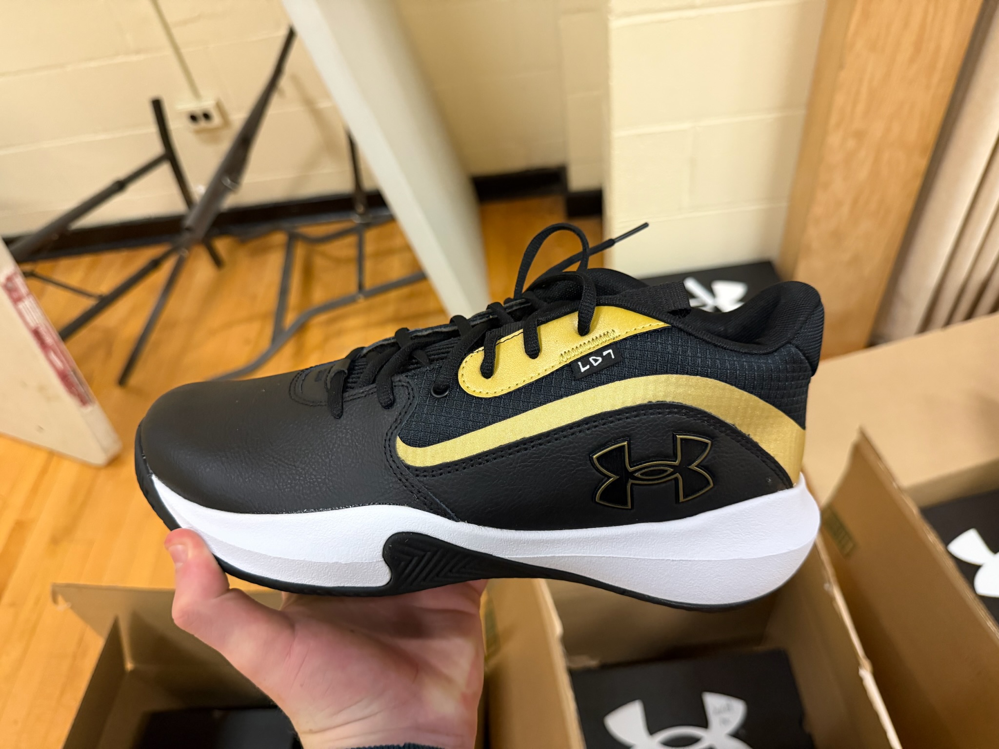 A black and gold Under Armour basketball sneaker from the team donation