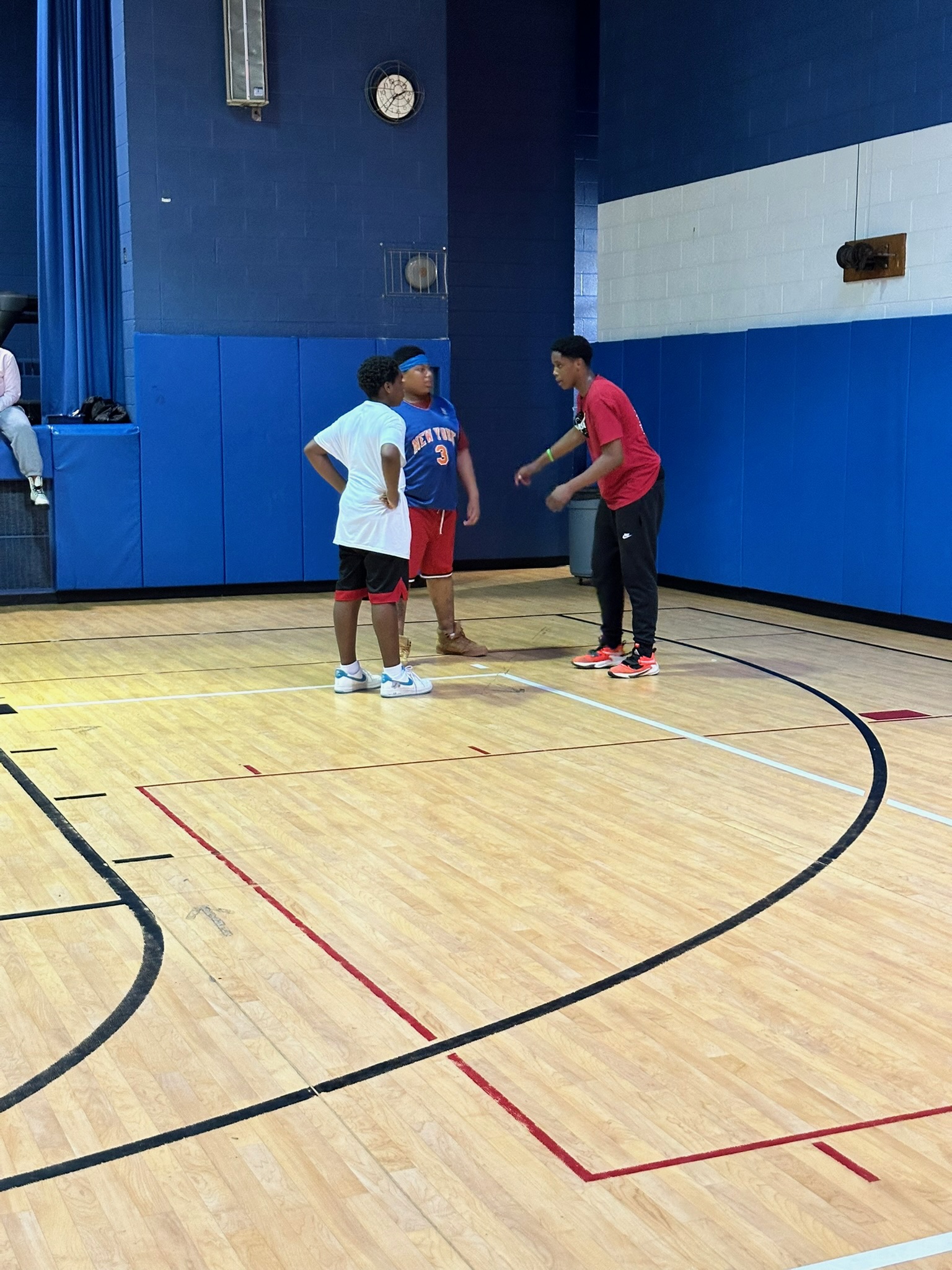 Players on the blue-walled indoor court at the first Hoops for Hope tournament